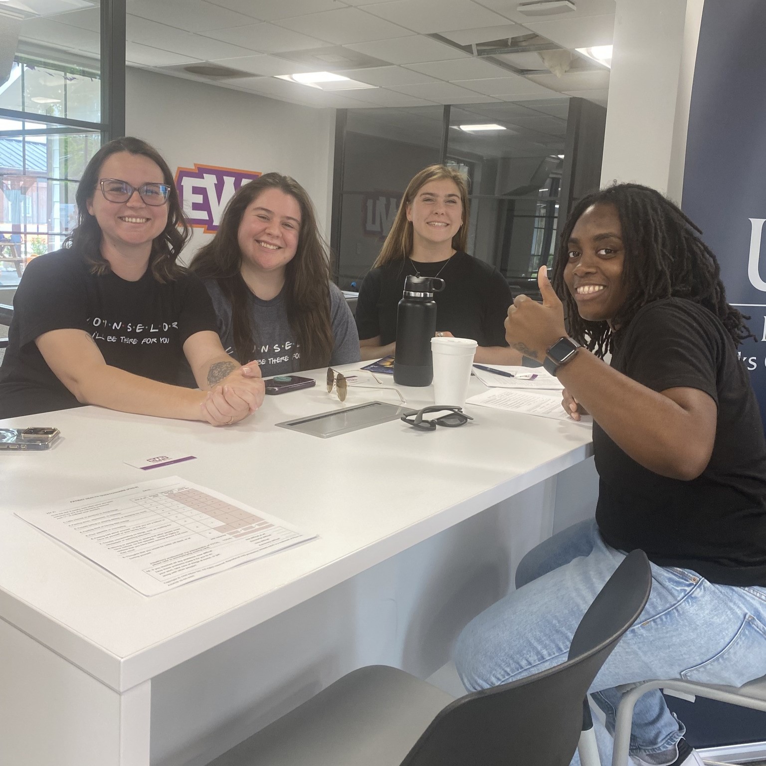 CMHC and CAMS students sitting at a table smiling