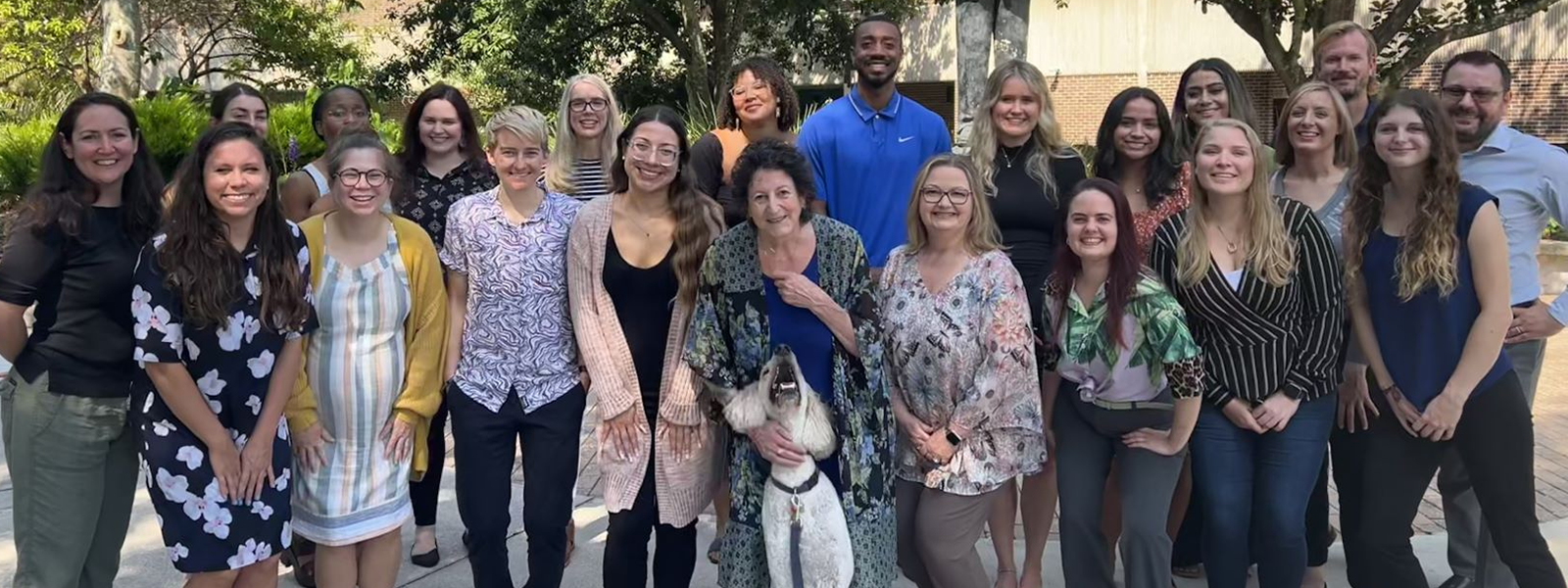 group of staff smiling outside