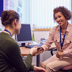 a student talking with a counselor in an office