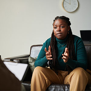 a student on a couch talking with a counselor