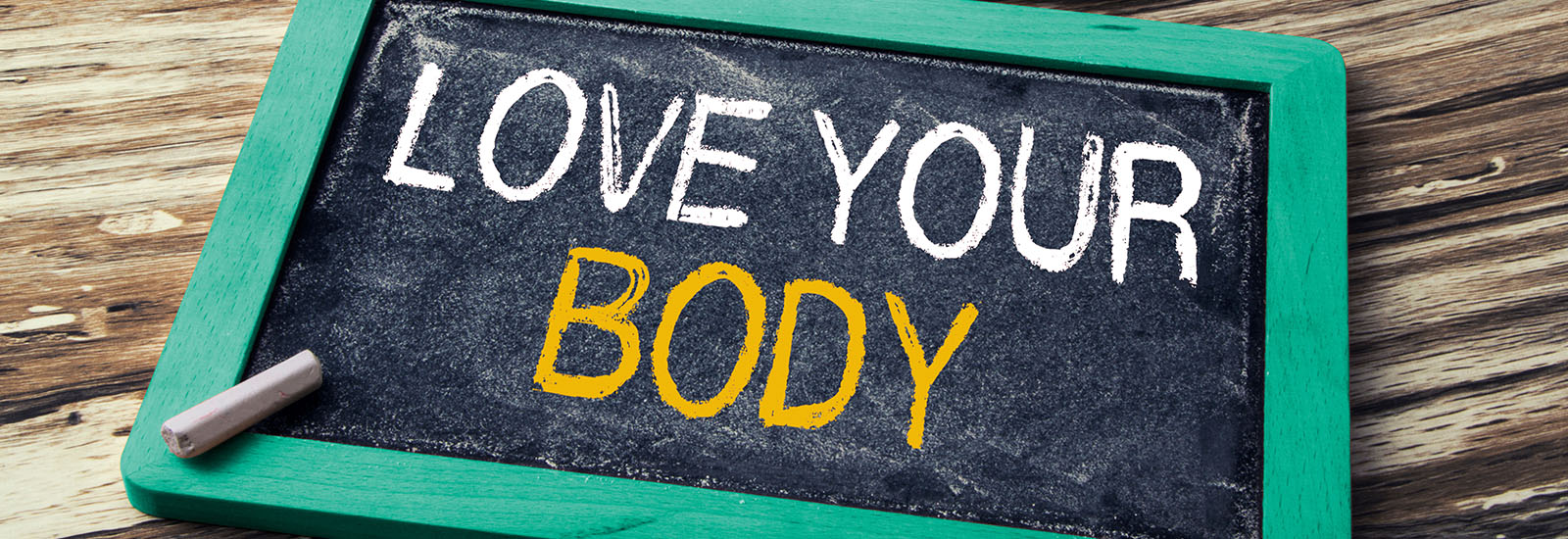 love your body written on a chalkboard