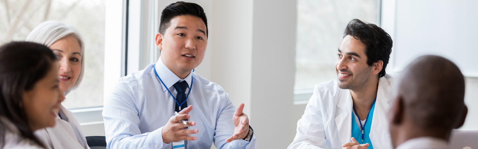 Health administrators having a conversation at a table. 
