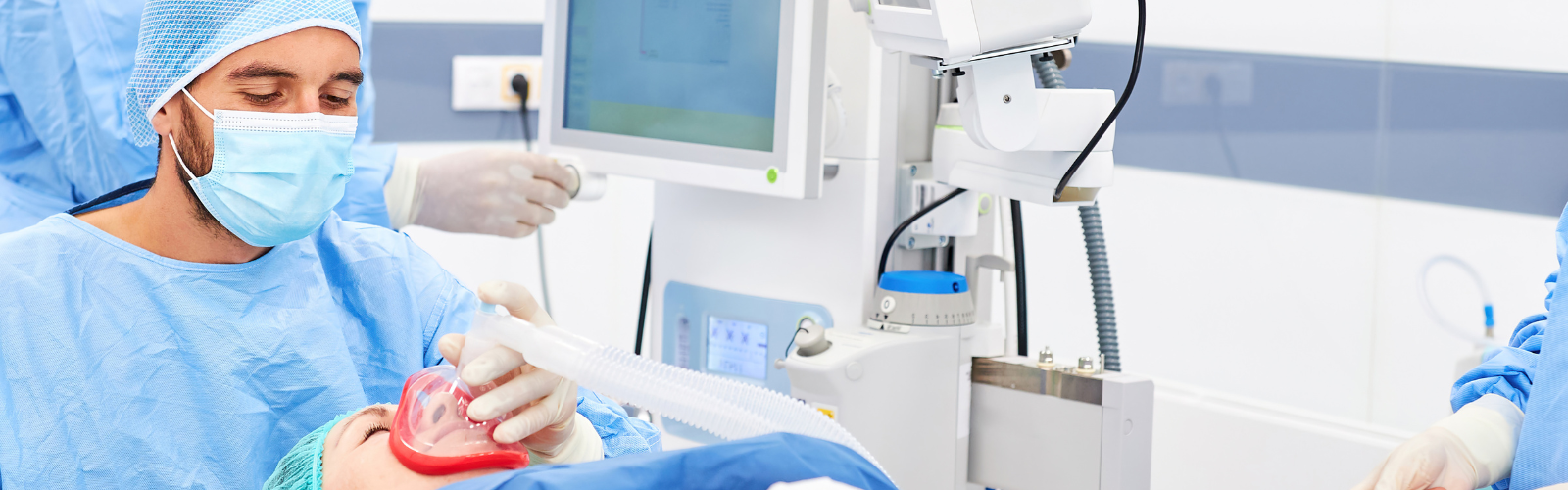 male anesthesiology nurse applying a mask to a patient laying down