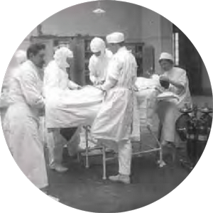 Nurses in the early 1900s working on a patient
