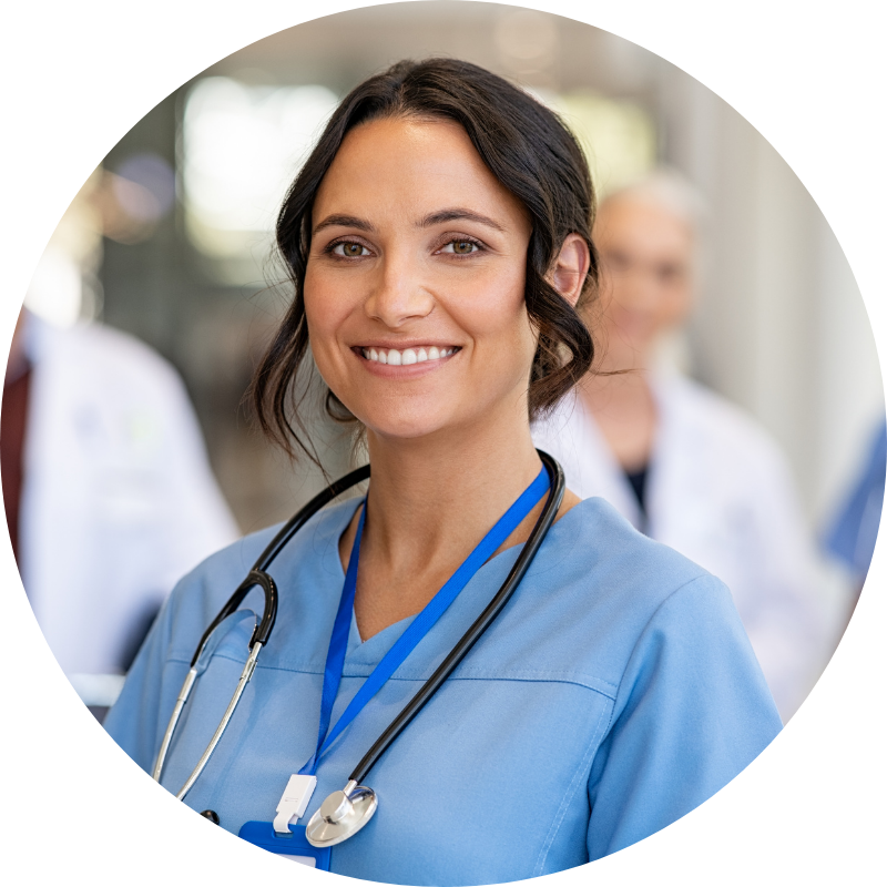 nurse wearing a light blue scrub with a badge and stethoscope around her neck