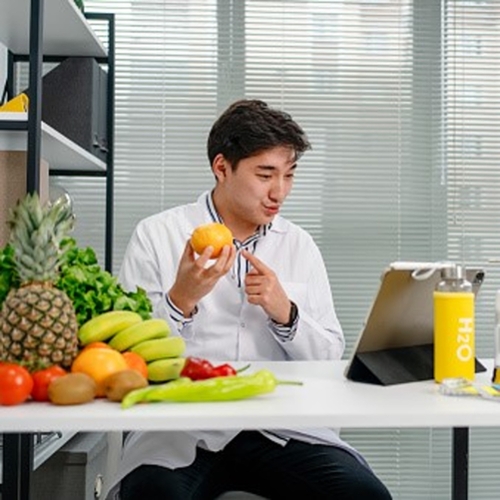 man holding fruit looking at clipboard