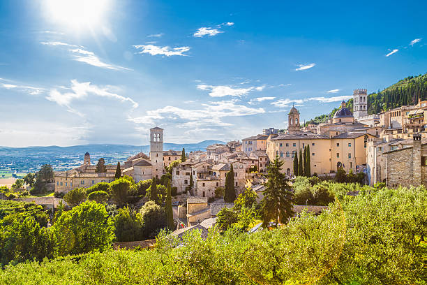 landscape image of umbria with sky, buildings, and green grass