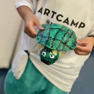 child showing off her paper turtle