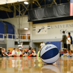 basketball on a court with kids in the background