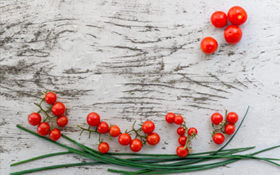 tomatoes and chives on a white wood background