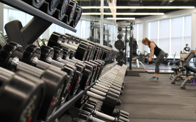 a woman lifting weights at the gym