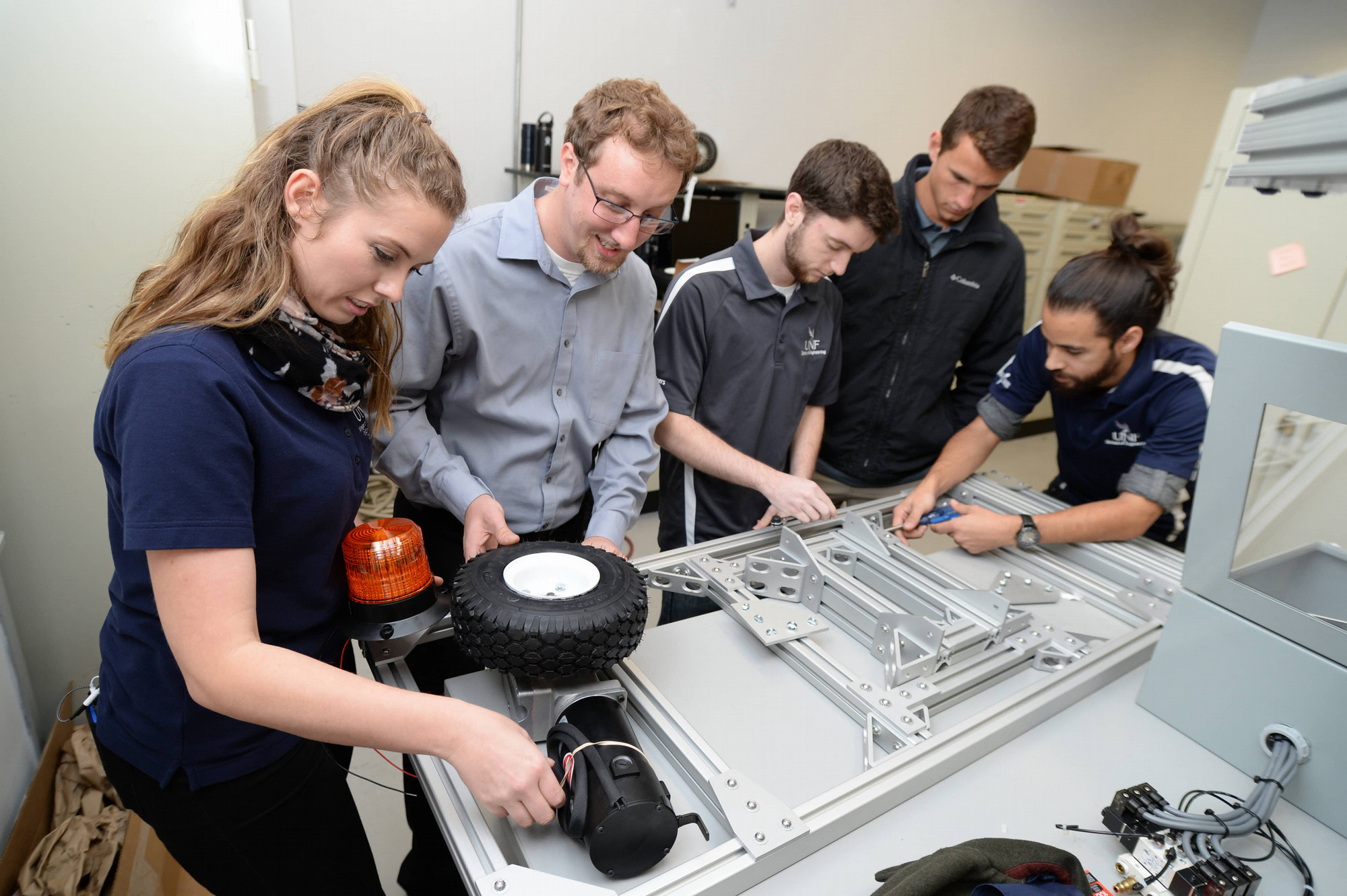 Group of students building a large wheeled robot