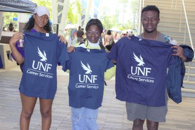 Student Resources with students holding shirts