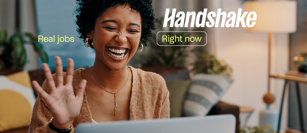 Woman waving at her laptop screen as if she is interviewing