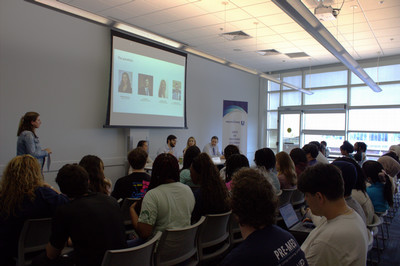Professional u panel guests standing by banner