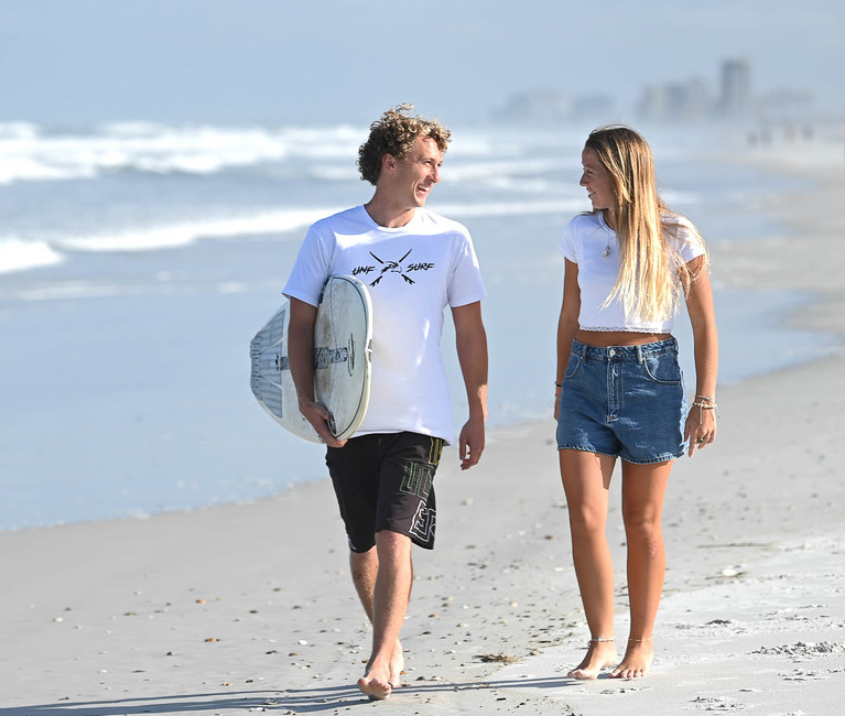 two students talking on the beach