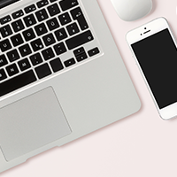 laptop and phone on a pink background