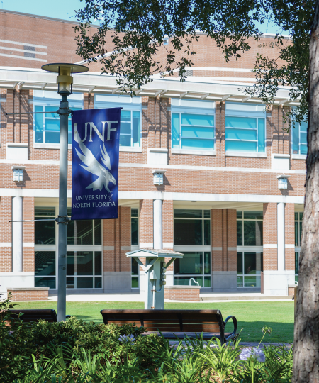 campus with UNF sign on lamppost
