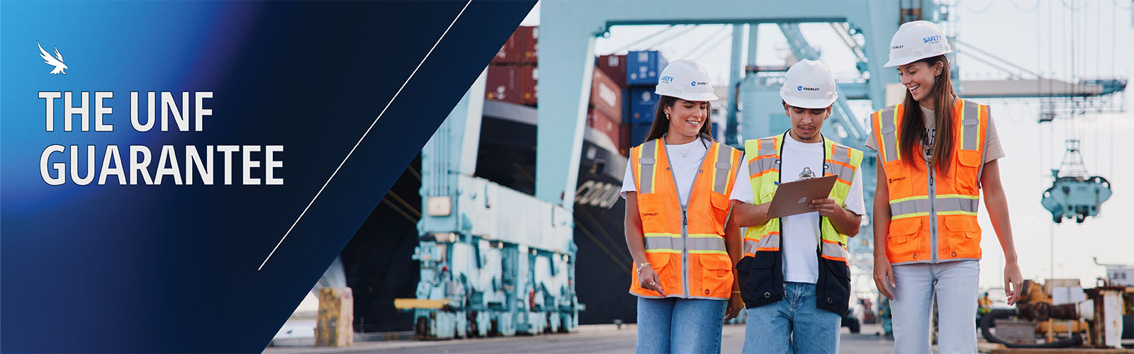 the unf guarantee and three students walking at Jaxport in hard hats
