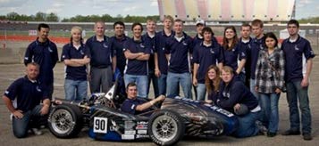 Students standing behind the UNF racecar team