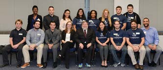 Steve Wozniak sitting with students posing for picture.