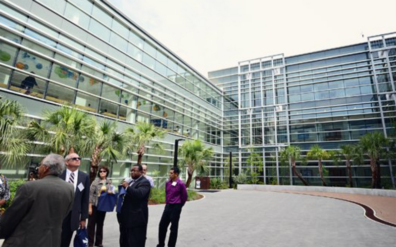 people dressed in business attire standing in UNF Biology courtyard