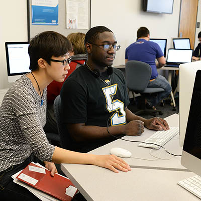 two people looking at a computer