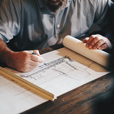 a man drawing architectural plans
