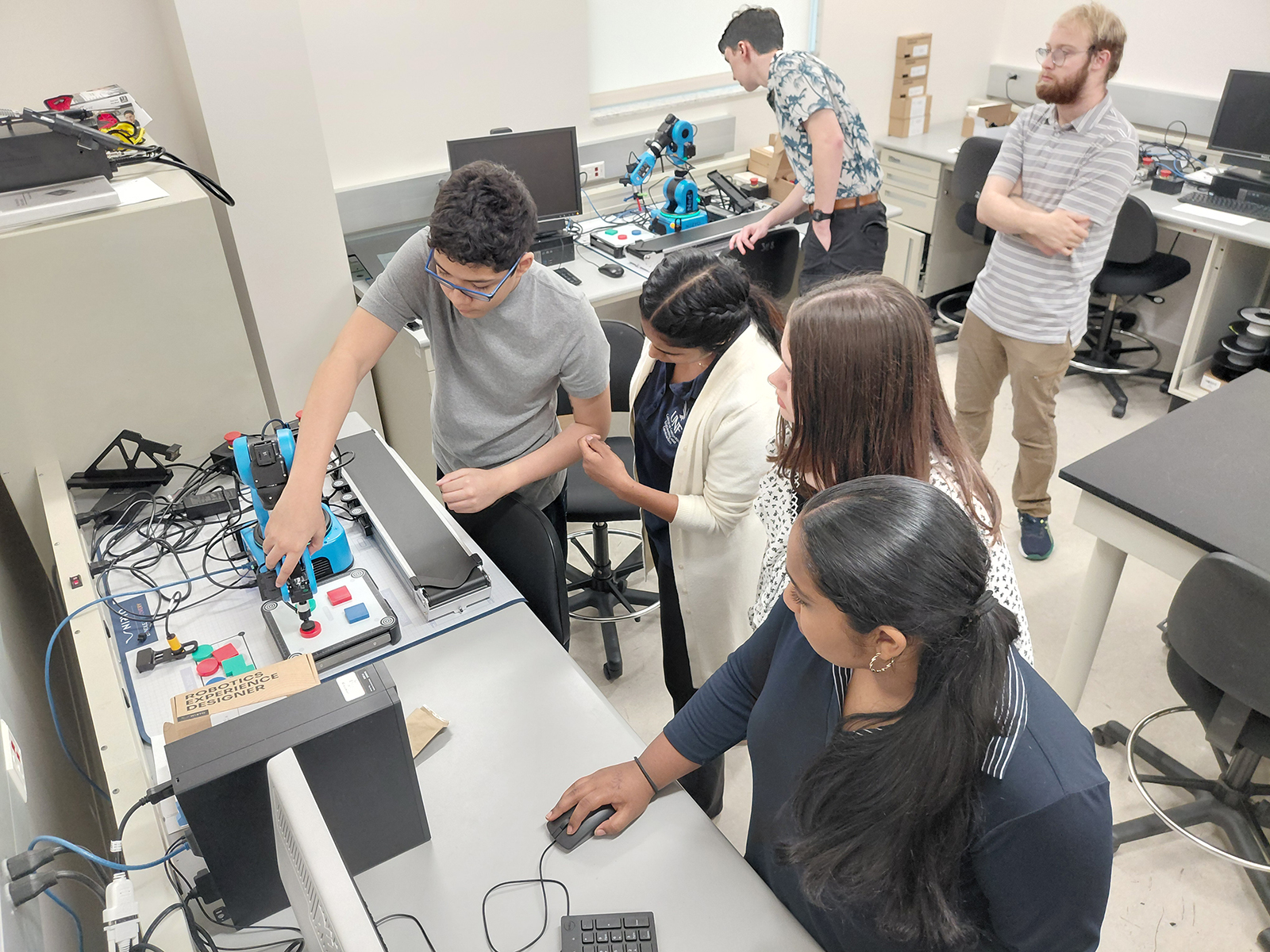 Students working with equipment to design robotics