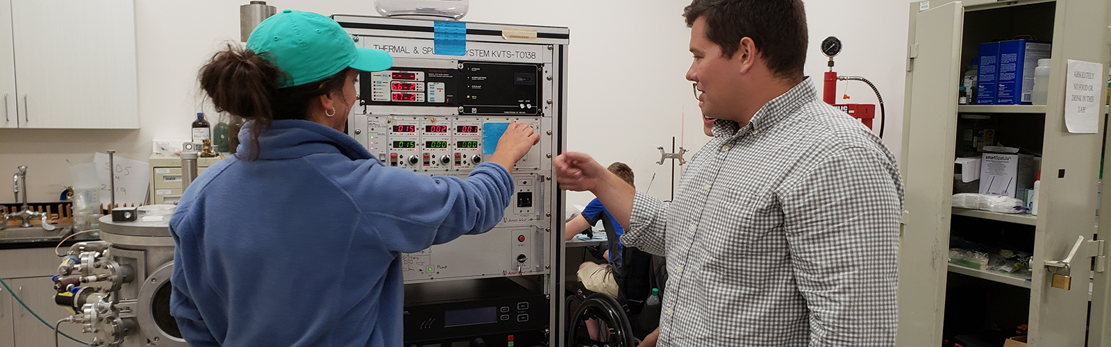 Student and Professor working on equipment