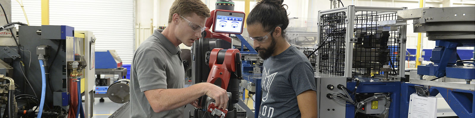 two men working on a robot