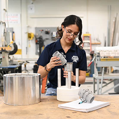 a woman putting together a machine