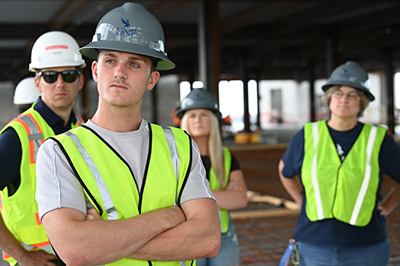four construction management students standing