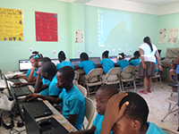 A room full of children working with laptops