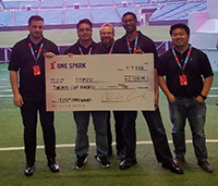 five men holding a large check