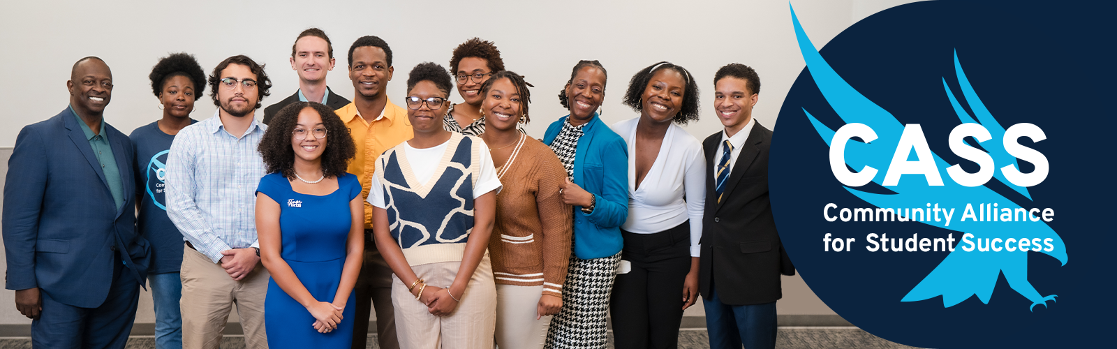 Group shot with everyone in their professional outfits and the CASS logo on the right