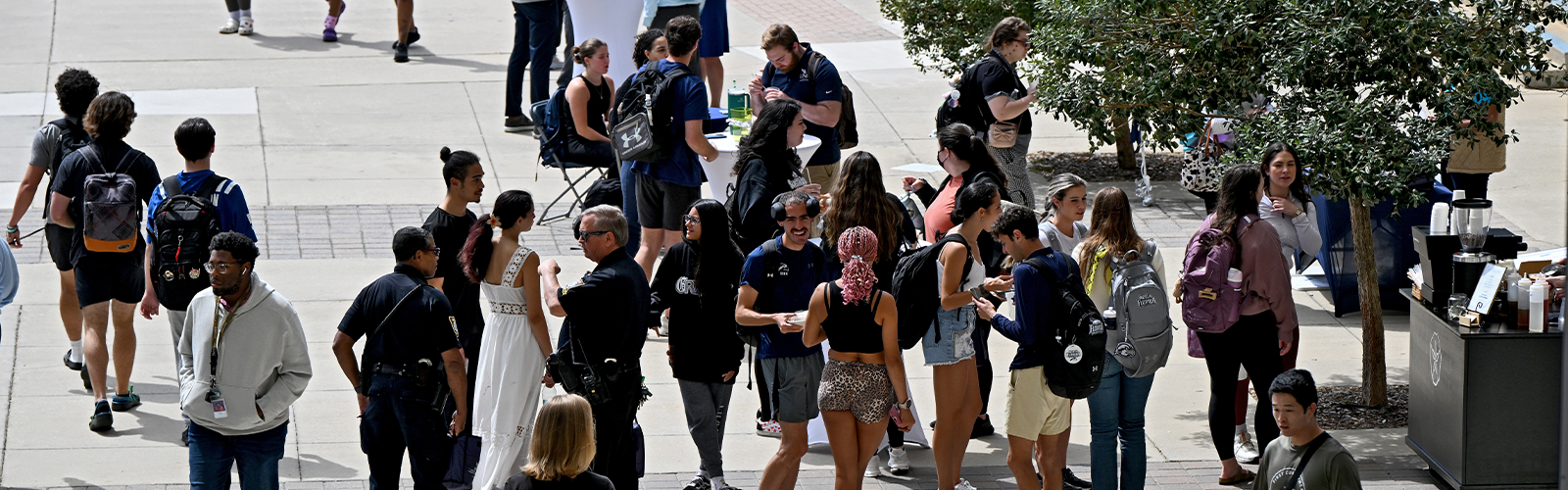 Crowd shot of people enjoying an event and they are chatting and eating food