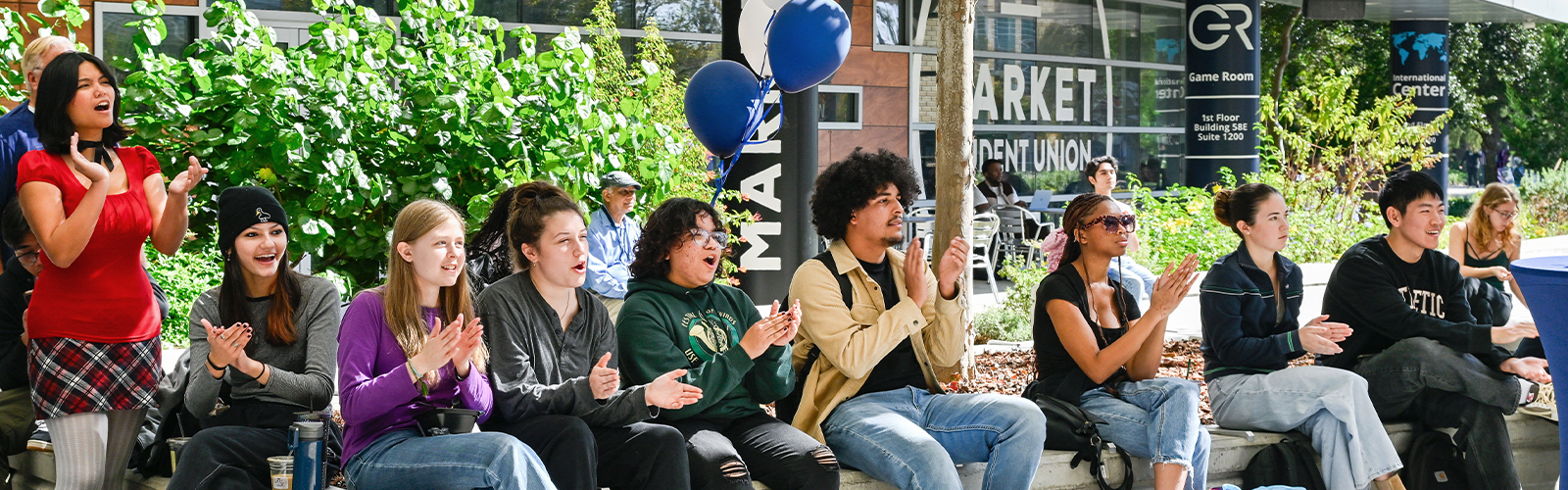 Group of students having a great time and clapping
