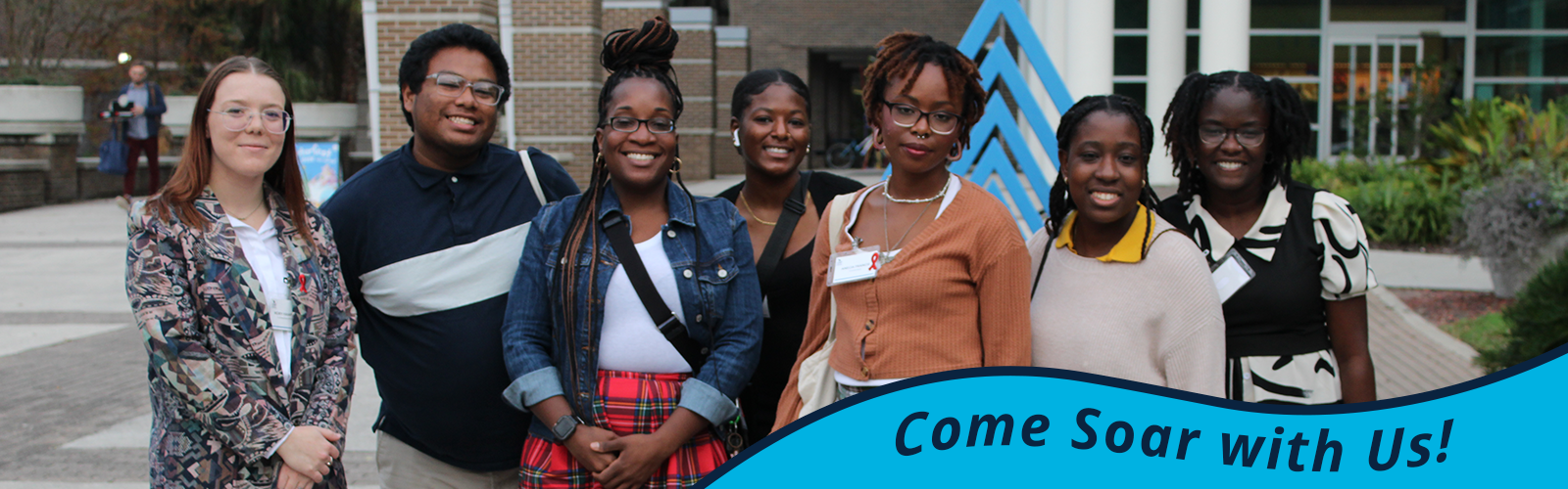 Smiling Connection group wearing business attire; in bottom right, text saying 'Come Soar with Us'