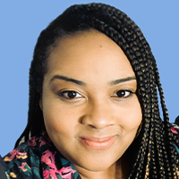 Monique Stewart is smiling and wearing a dark top with colorful design