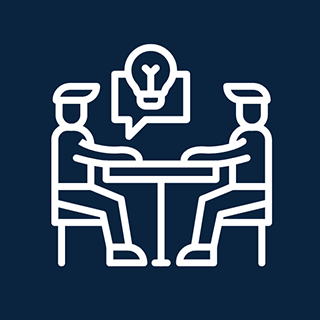 Outline of two people sitting at a table and one is speaking with an idea light bulb