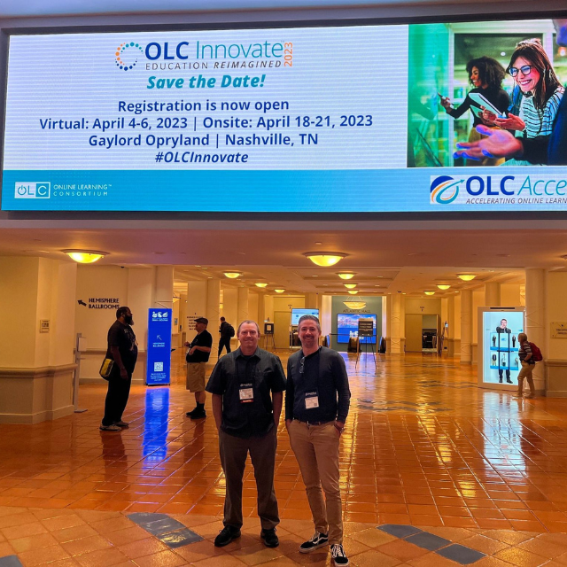 two men standing in a conference hall