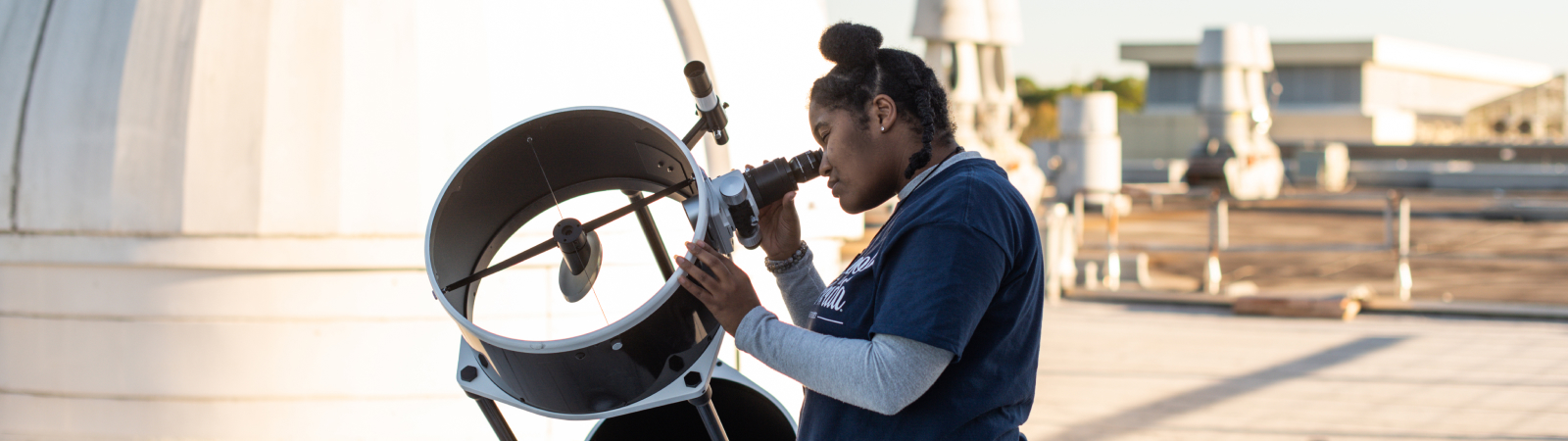 Girl looking through telescope