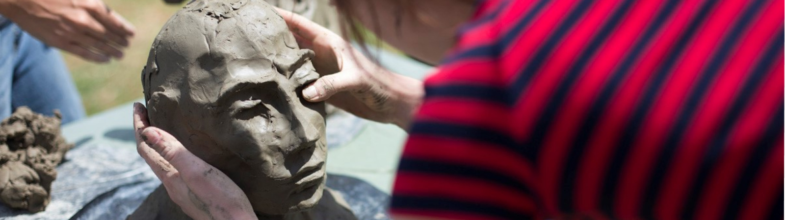 A student sculpting a clay head