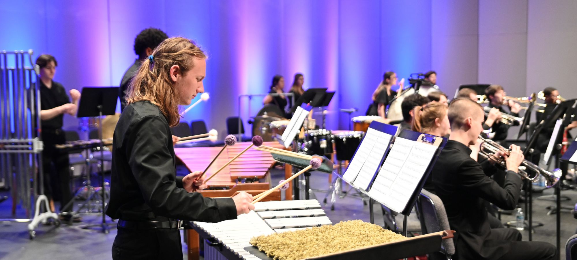 Students playing percussion instruments in music performance