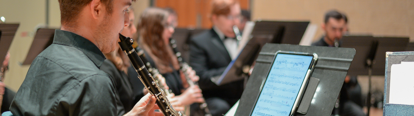 clarinet player reading music off a tablet