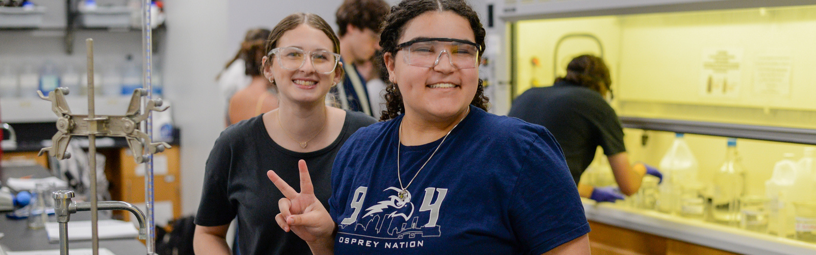 Two chemistry students in a lab smiling