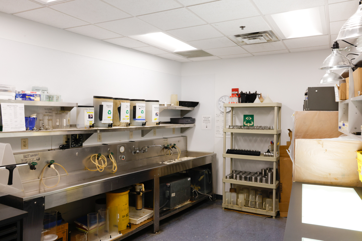 Photography lab with development equipment and camera setup.