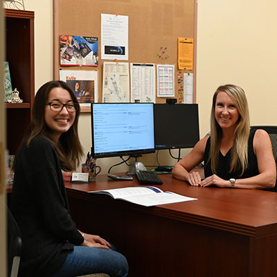 Student and academic advisor at a desk