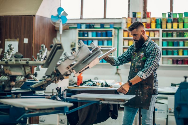 Screen printer works in a colorful production studio